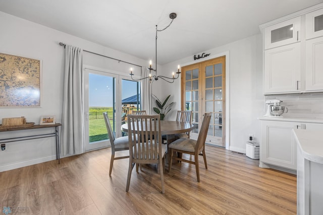8871 Cottonwood Blvd, Horace, ND 58047 - dining room featuring light wood-style flooring, a chandelier, and french doors