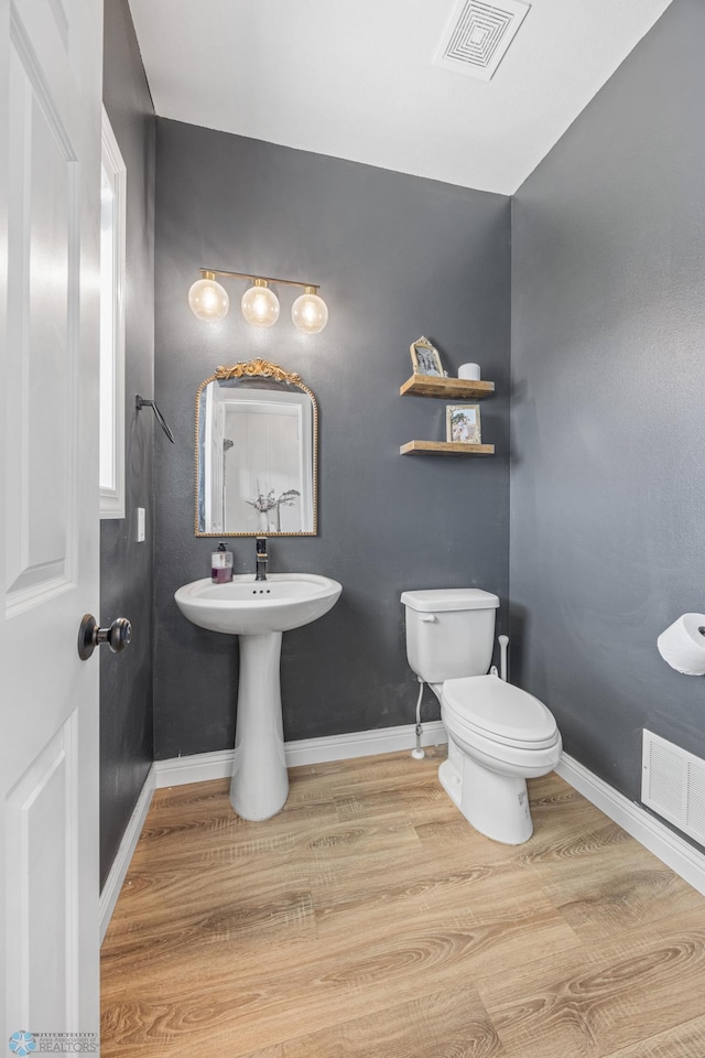 8871 Cottonwood Blvd, Horace, ND 58047 - half bath with wood finished floors and toilet