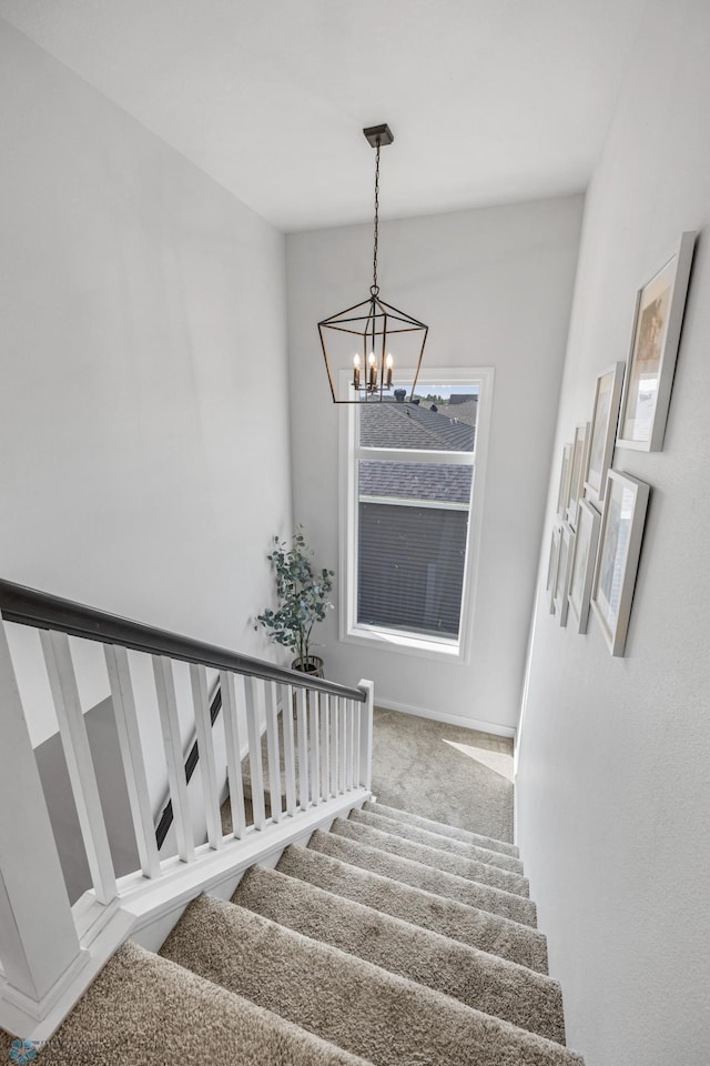 8871 Cottonwood Blvd, Horace, ND 58047 - stairway with a chandelier and carpet floors