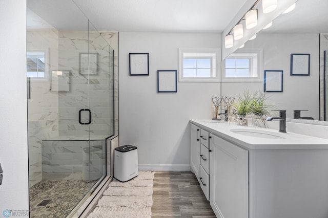 8871 Cottonwood Blvd, Horace, ND 58047 - full bathroom with double vanity, a shower stall, and wood finished floors