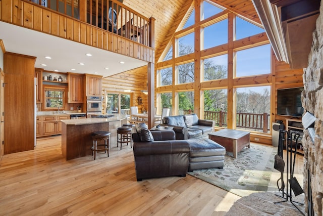 15193 Wilderness Trl, Crosslake, MN 56442 - living area with high vaulted ceiling, light wood finished floors, and recessed lighting