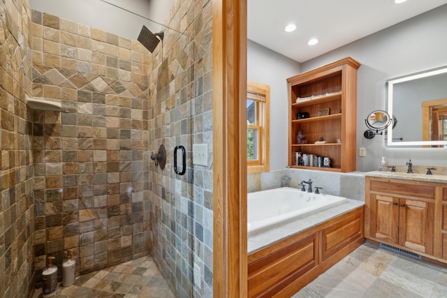 15193 Wilderness Trl, Crosslake, MN 56442 - full bath with a stall shower, a bath, vanity, and recessed lighting