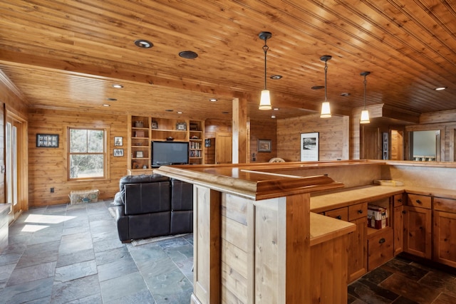 15193 Wilderness Trl, Crosslake, MN 56442 - kitchen featuring wood ceiling, pendant lighting, light countertops, open floor plan, and stone tile floors