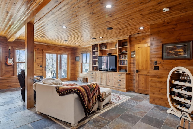15193 Wilderness Trl, Crosslake, MN 56442 - living room featuring stone tile flooring, wood walls, wooden ceiling, and recessed lighting