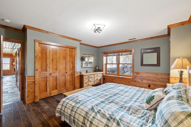 15193 Wilderness Trl, Crosslake, MN 56442 - bedroom featuring dark wood finished floors, multiple windows, wainscoting, a closet, and wood walls