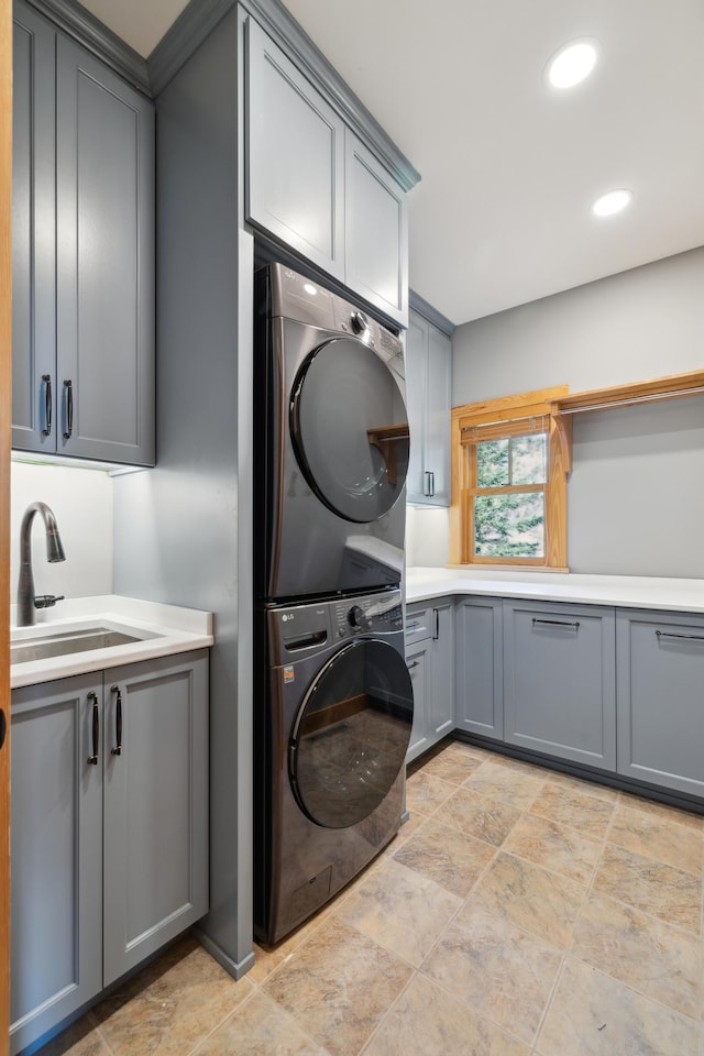 15193 Wilderness Trl, Crosslake, MN 56442 - laundry area featuring stacked washer / drying machine, cabinet space, stone finish floors, and recessed lighting