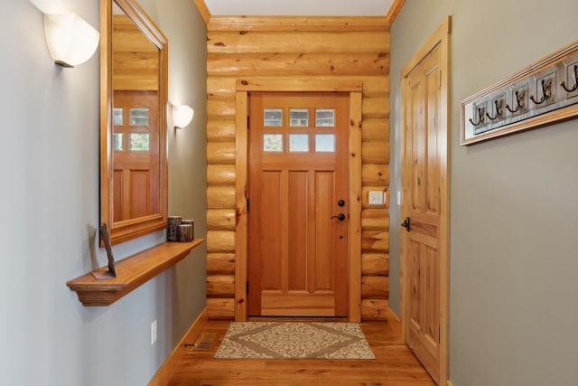 15193 Wilderness Trl, Crosslake, MN 56442 - entryway featuring log walls and wood finished floors