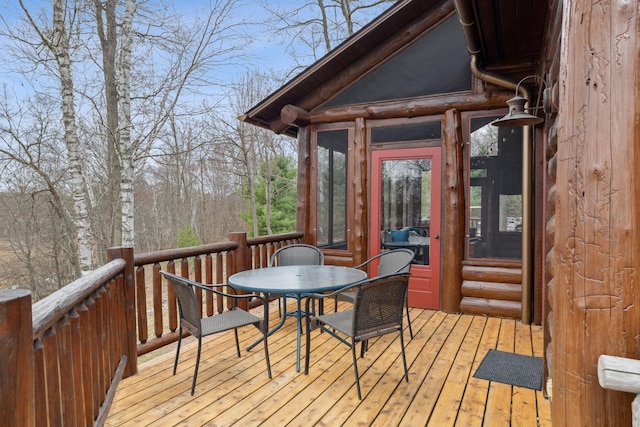 15193 Wilderness Trl, Crosslake, MN 56442 - wooden terrace with outdoor dining area and a sunroom