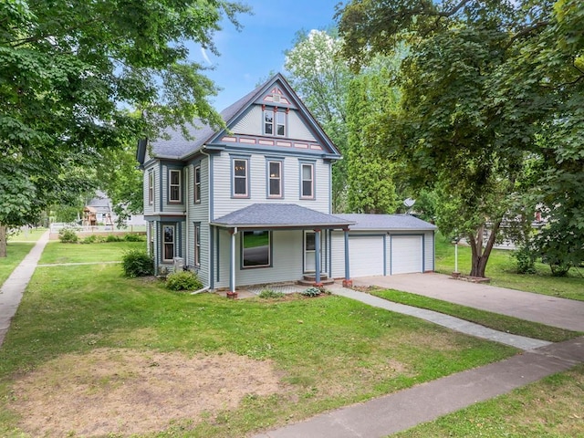 202 Cedar St, Pepin, WI 54759 - victorian-style house with covered porch, a front yard, driveway, and a shingled roof