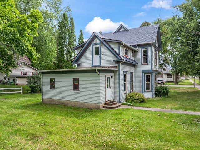 202 Cedar St, Pepin, WI 54759 - view of front of home with a front yard and a shingled roof