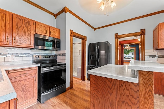 202 Cedar St, Pepin, WI 54759 - kitchen with stainless steel microwave, electric stove, fridge with ice dispenser, ornamental molding, and light wood-type flooring