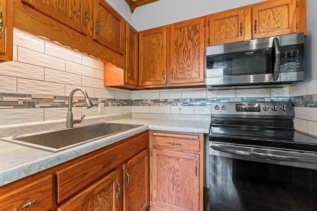 202 Cedar St, Pepin, WI 54759 - kitchen with appliances with stainless steel finishes, decorative backsplash, light countertops, and brown cabinets