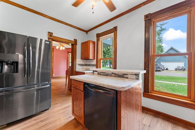 202 Cedar St, Pepin, WI 54759 - kitchen featuring stainless steel appliances, light countertops, ornamental molding, decorative backsplash, and healthy amount of natural light