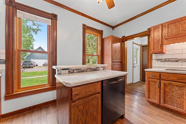 202 Cedar St, Pepin, WI 54759 - kitchen with dishwasher, ornamental molding, light wood-style floors, light countertops, and decorative backsplash
