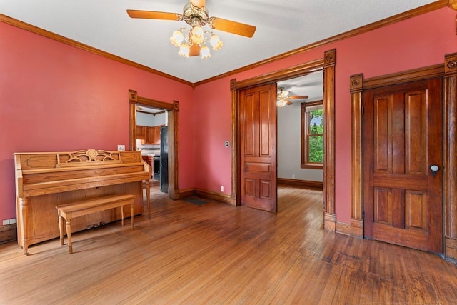 202 Cedar St, Pepin, WI 54759 - sitting room featuring a ceiling fan, light wood-style flooring, and ornamental molding