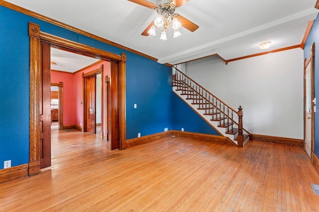 202 Cedar St, Pepin, WI 54759 - empty room with hardwood / wood-style flooring, ornamental molding, ceiling fan, and stairs