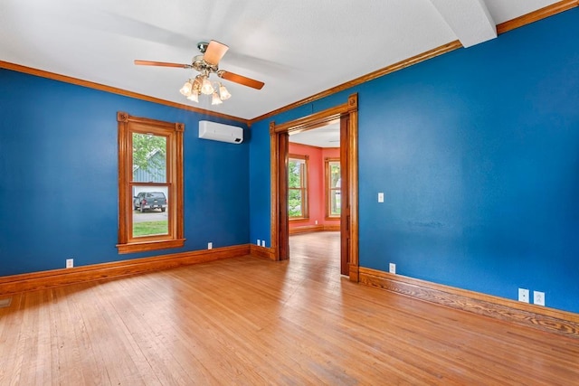 202 Cedar St, Pepin, WI 54759 - unfurnished room with a wall mounted AC, crown molding, wood finished floors, and a ceiling fan