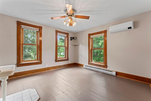 202 Cedar St, Pepin, WI 54759 - empty room featuring baseboard heating, a wall unit AC, hardwood / wood-style flooring, and a ceiling fan