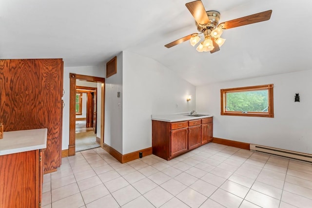 202 Cedar St, Pepin, WI 54759 - interior space featuring vaulted ceiling, light countertops, baseboard heating, ceiling fan, and brown cabinetry