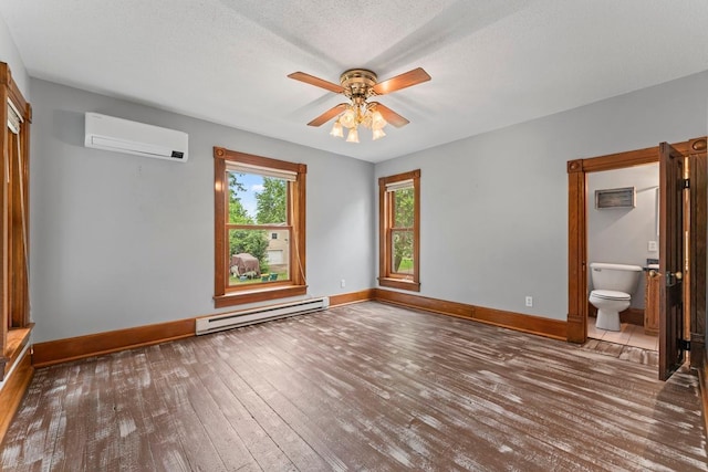 202 Cedar St, Pepin, WI 54759 - unfurnished room with an AC wall unit, a baseboard heating unit, a ceiling fan, and wood-type flooring