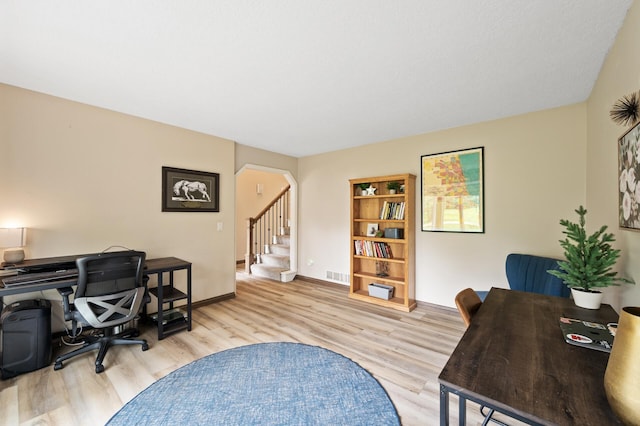 9950 204th Street Ct N, Forest Lake, MN 55025 - home office featuring arched walkways and wood finished floors