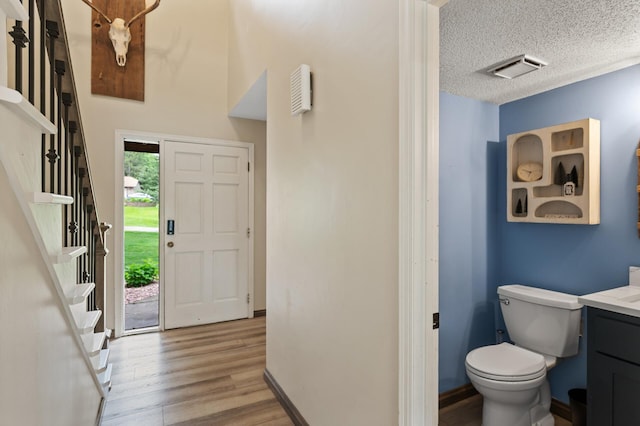 9950 204th Street Ct N, Forest Lake, MN 55025 - foyer with wood finished floors and a textured ceiling