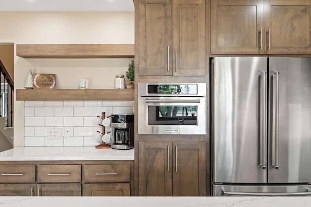 9950 204th Street Ct N, Forest Lake, MN 55025 - kitchen featuring appliances with stainless steel finishes, tasteful backsplash, light countertops, and open shelves