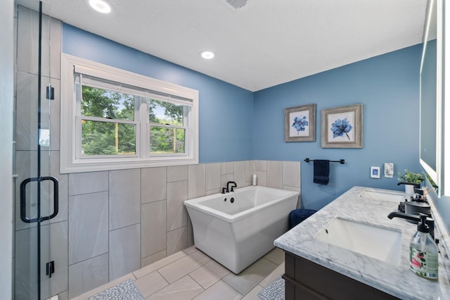 9950 204th Street Ct N, Forest Lake, MN 55025 - full bathroom with double vanity, tile walls, a freestanding tub, tile patterned floors, and a shower stall