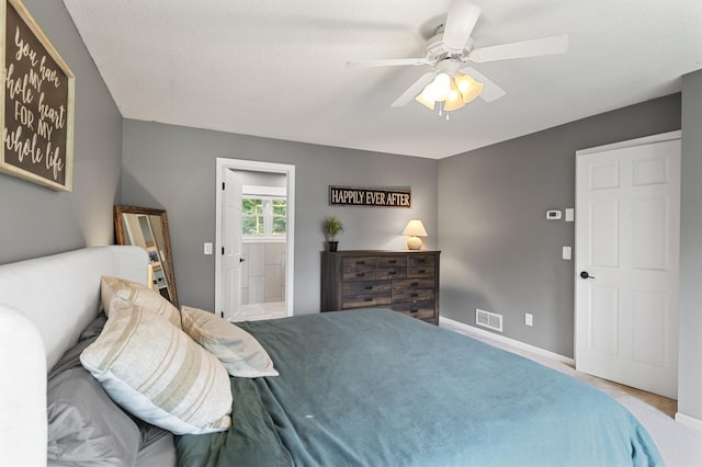 9950 204th Street Ct N, Forest Lake, MN 55025 - carpeted bedroom featuring a ceiling fan and ensuite bath
