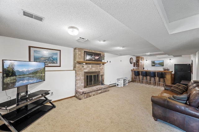 9950 204th Street Ct N, Forest Lake, MN 55025 - living room featuring bar with sink, carpet floors, a brick fireplace, a textured ceiling, and a baseboard radiator