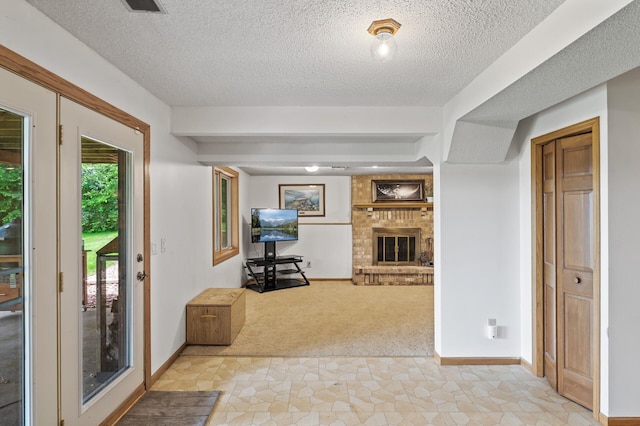9950 204th Street Ct N, Forest Lake, MN 55025 - entrance foyer with light carpet, a textured ceiling, and a fireplace