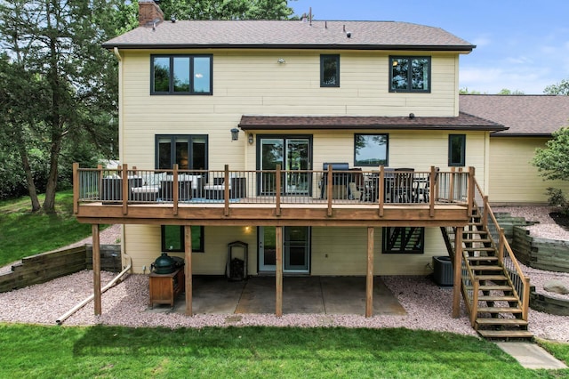 9950 204th Street Ct N, Forest Lake, MN 55025 - rear view of house featuring a wooden deck, stairs, a patio, a chimney, and a lawn