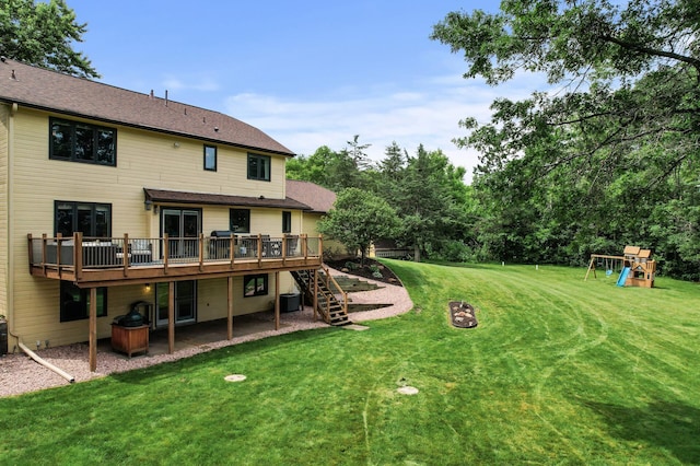 9950 204th Street Ct N, Forest Lake, MN 55025 - view of green lawn featuring a wooden deck, stairway, an outdoor fire pit, a patio area, and a playground