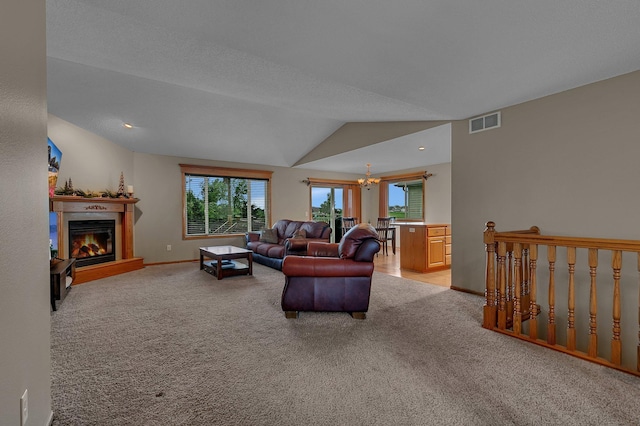 1664 Payton Ct NE, Sauk Rapids, MN 56379 - living area with light colored carpet, a chandelier, plenty of natural light, a glass covered fireplace, and lofted ceiling