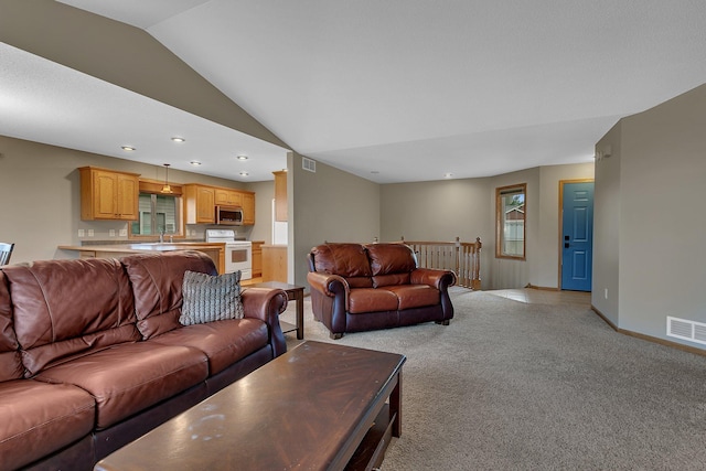 1664 Payton Ct NE, Sauk Rapids, MN 56379 - living room featuring light carpet and vaulted ceiling