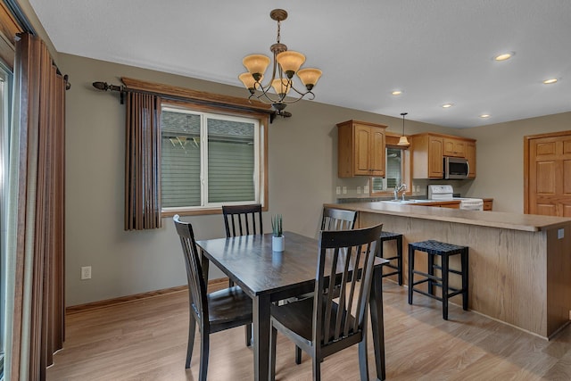 1664 Payton Ct NE, Sauk Rapids, MN 56379 - dining room with light wood finished floors, a chandelier, recessed lighting, and plenty of natural light