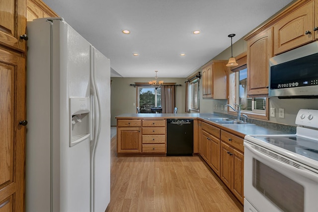 1664 Payton Ct NE, Sauk Rapids, MN 56379 - kitchen with white appliances, light wood-style floors, a chandelier, a peninsula, and hanging light fixtures