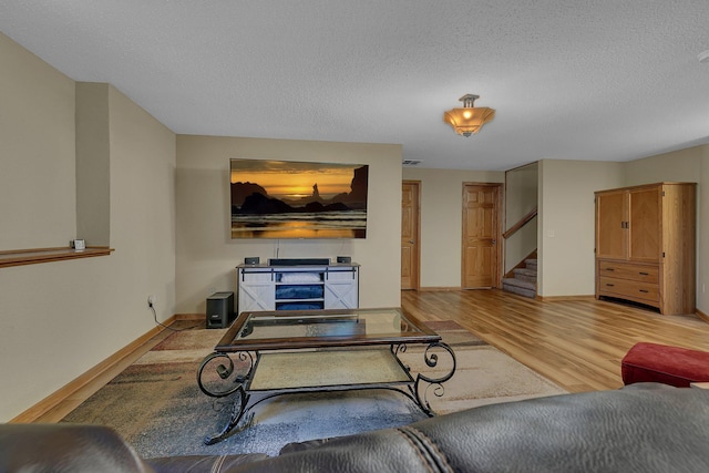 1664 Payton Ct NE, Sauk Rapids, MN 56379 - living area featuring stairs, light wood finished floors, and a textured ceiling
