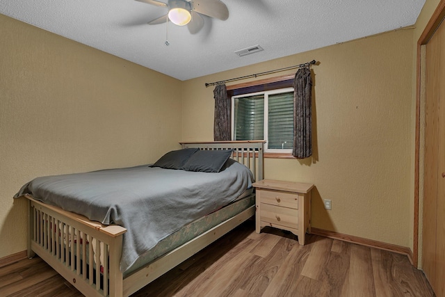 1664 Payton Ct NE, Sauk Rapids, MN 56379 - bedroom featuring wood finished floors, ceiling fan, and a textured ceiling
