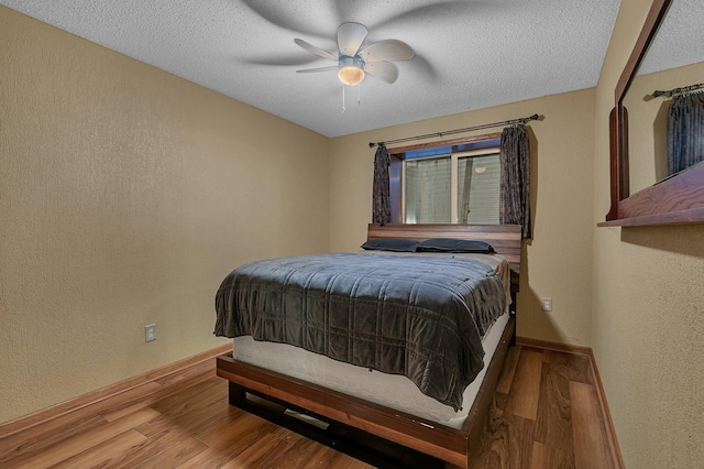 1664 Payton Ct NE, Sauk Rapids, MN 56379 - bedroom featuring wood finished floors, a ceiling fan, a textured wall, and a textured ceiling