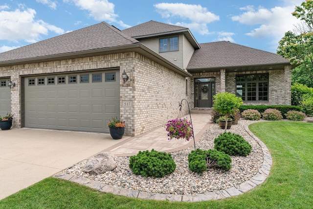 517 Redpoll Ave SE, New Prague, MN 56071 - view of front of property with brick siding, an attached garage, a front yard, a shingled roof, and driveway