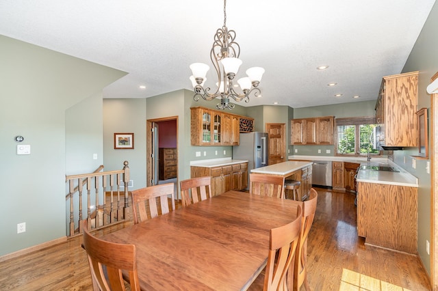 517 Redpoll Ave SE, New Prague, MN 56071 - dining space featuring wood finished floors, a chandelier, and recessed lighting