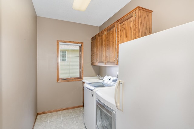 517 Redpoll Ave SE, New Prague, MN 56071 - laundry area featuring cabinet space, washing machine and clothes dryer, and light tile patterned flooring