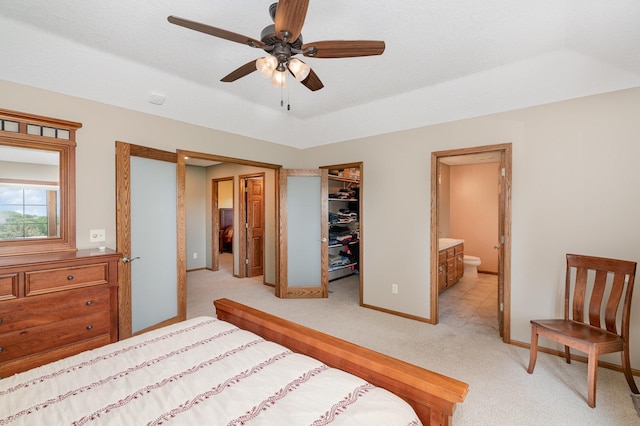 517 Redpoll Ave SE, New Prague, MN 56071 - bedroom with light colored carpet, a closet, a spacious closet, ensuite bathroom, and ceiling fan