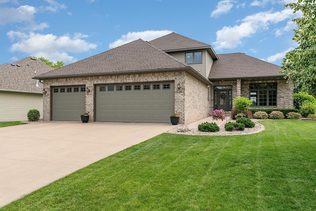 517 Redpoll Ave SE, New Prague, MN 56071 - view of front of house with brick siding, an attached garage, driveway, and a front lawn