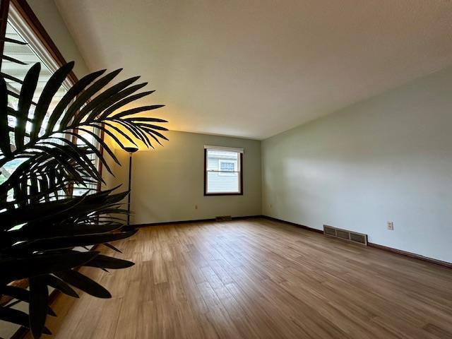 2671 4th Ave NE, Rochester, MN 55906 - unfurnished room with wood finished floors and baseboards