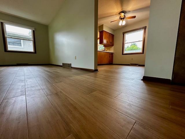 2671 4th Ave NE, Rochester, MN 55906 - unfurnished living room with a ceiling fan, lofted ceiling, and wood finished floors
