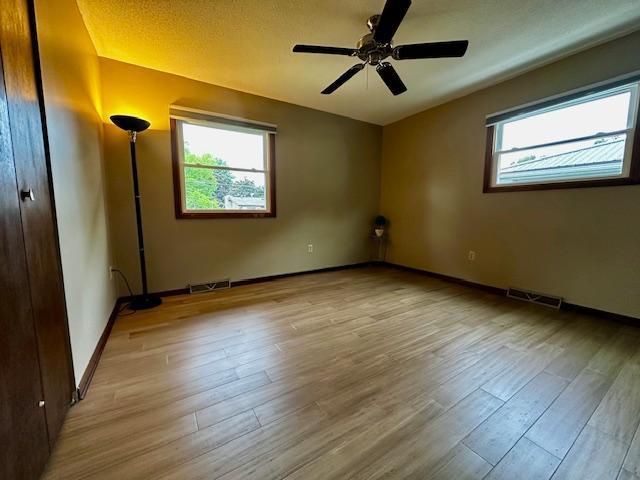 2671 4th Ave NE, Rochester, MN 55906 - unfurnished room featuring wood finished floors and a ceiling fan