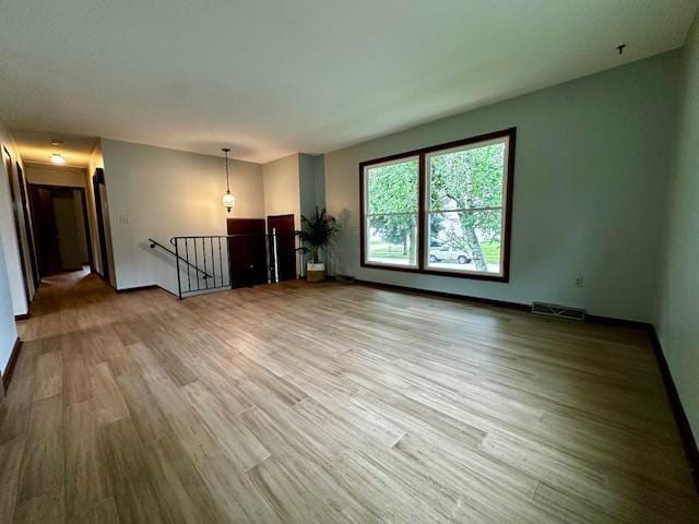 2671 4th Ave NE, Rochester, MN 55906 - unfurnished living room featuring wood finished floors and baseboards