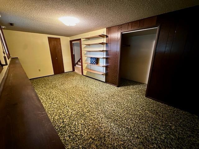 2671 4th Ave NE, Rochester, MN 55906 - unfurnished bedroom featuring a textured ceiling
